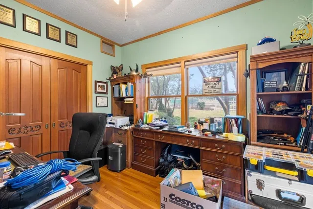 a bedroom with furniture and a large window