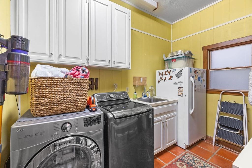 257 Encino Loop Kerrville, TX 78028 - Photo 24 of 92 a utility room with fridge dryer and washer