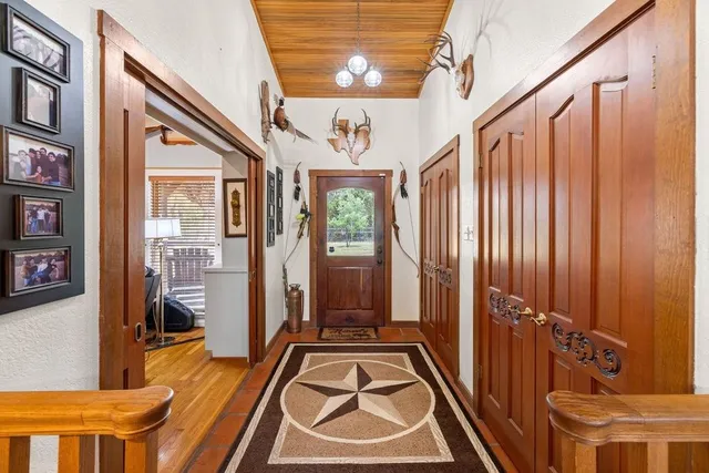 a living room with furniture a large window and a fireplace