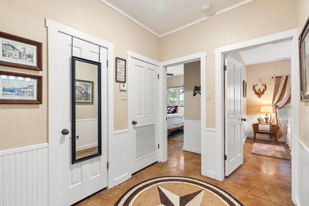 257 Encino Loop Kerrville, TX 78028 - Photo 31 of 92 a view of a hallway with bathroom and wooden floor