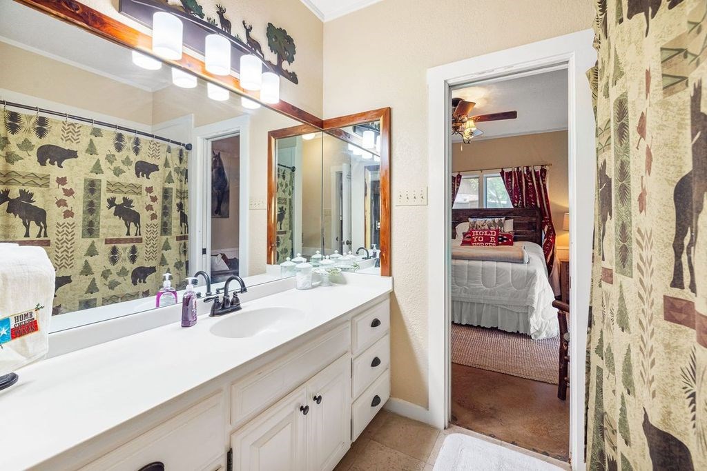 257 Encino Loop Kerrville, TX 78028 - Photo 38 of 92 a bathroom with a double vanity sink mirror and shower