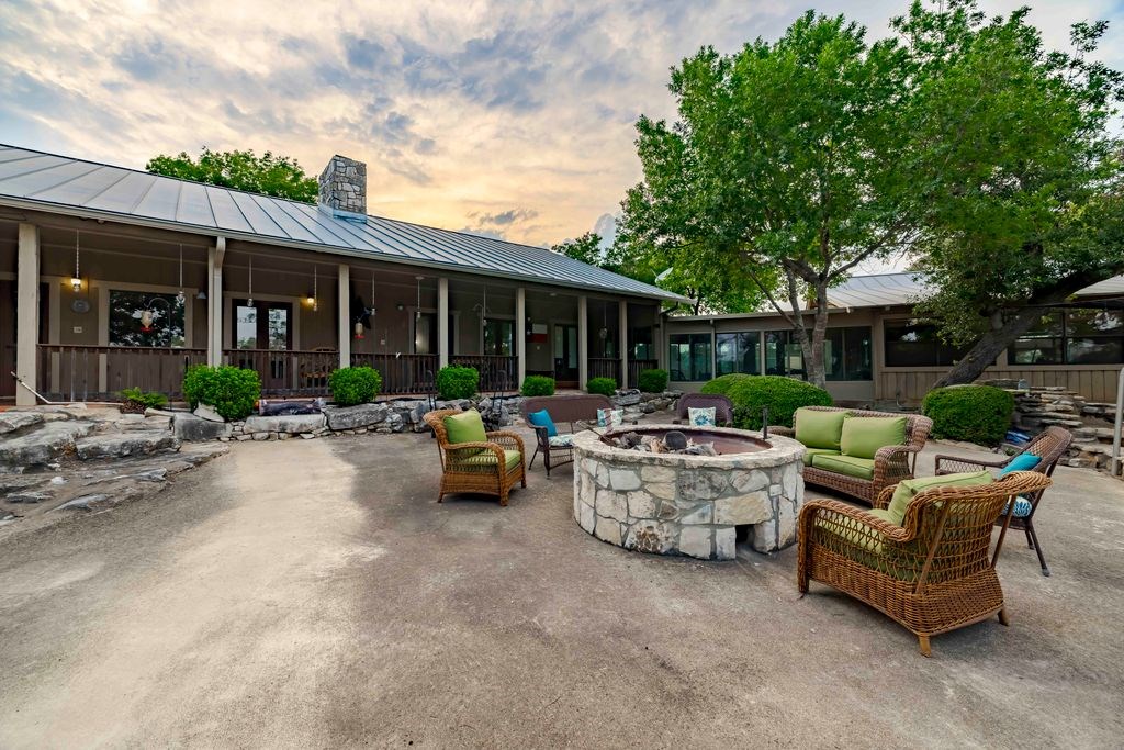 257 Encino Loop Kerrville, TX 78028 - Photo 50 of 92 a view of a patio with couches and a table and chairs with garden view