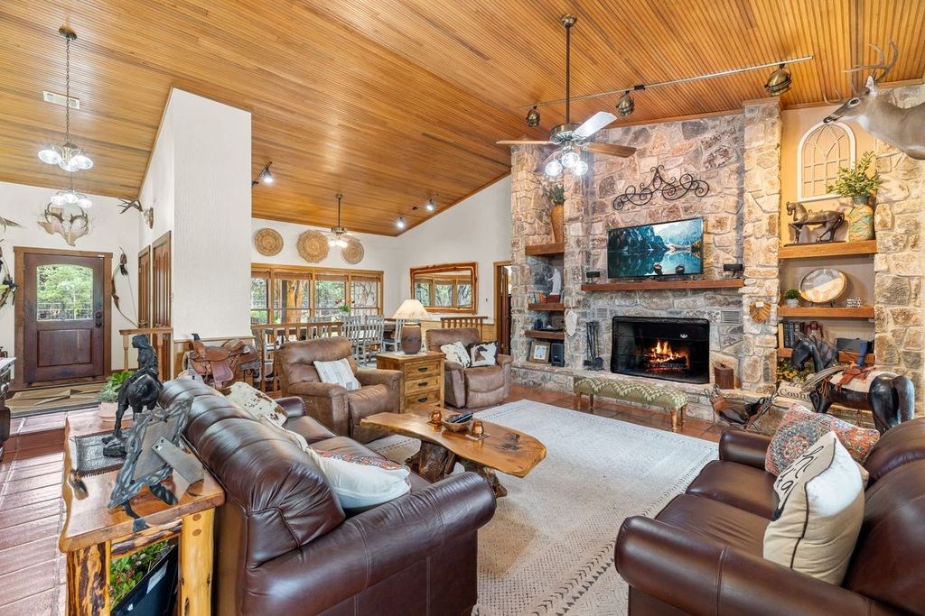 257 Encino Loop Kerrville, TX 78028 - Photo 5 of 92 a living room with furniture a large window and a fireplace