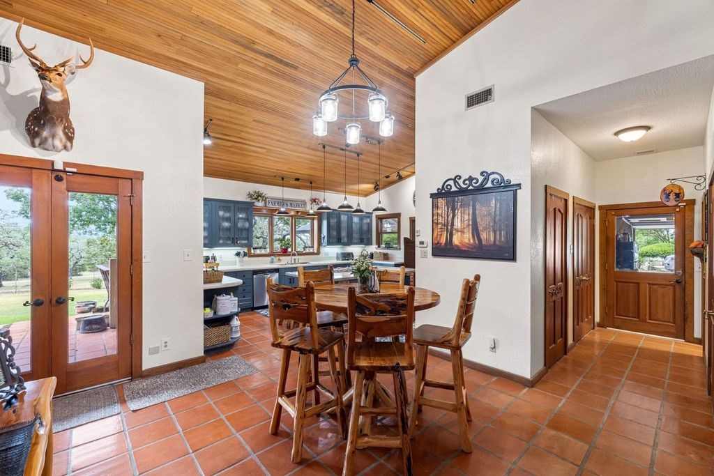 257 Encino Loop Kerrville, TX 78028 - Photo 6 of 92 a view of a dining room with furniture and chandelier