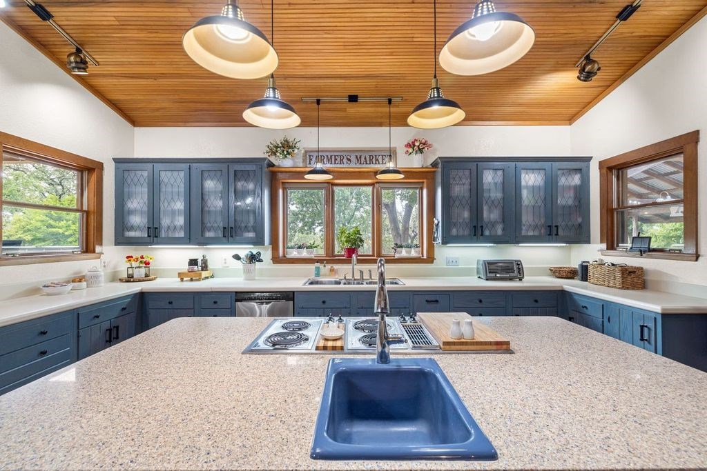 257 Encino Loop Kerrville, TX 78028 - Photo 8 of 92 a large kitchen with lots of counter space a large window and stainless steel appliances