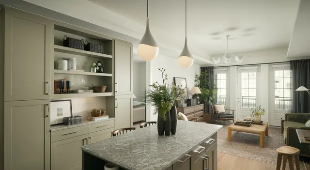 a kitchen with counter space a sink and living room view