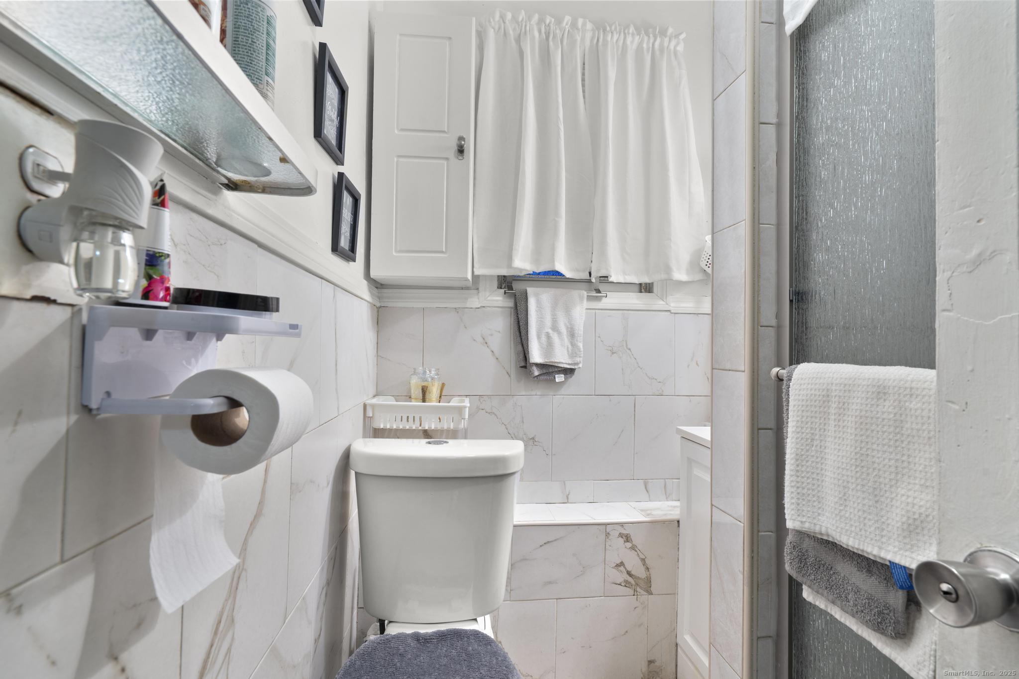 865 Iranistan Avenue Bridgeport, CT 06605 - Photo 16 of 35 a bathroom with sink mirror and toilet