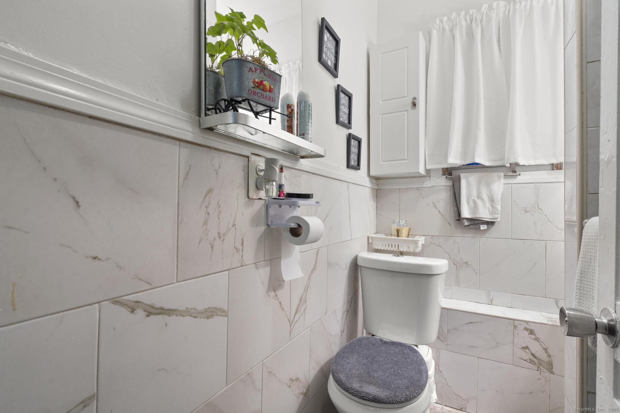 865 Iranistan Avenue Bridgeport, CT 06605 - Photo 17 of 35 a bathroom with a sink toilet and mirror