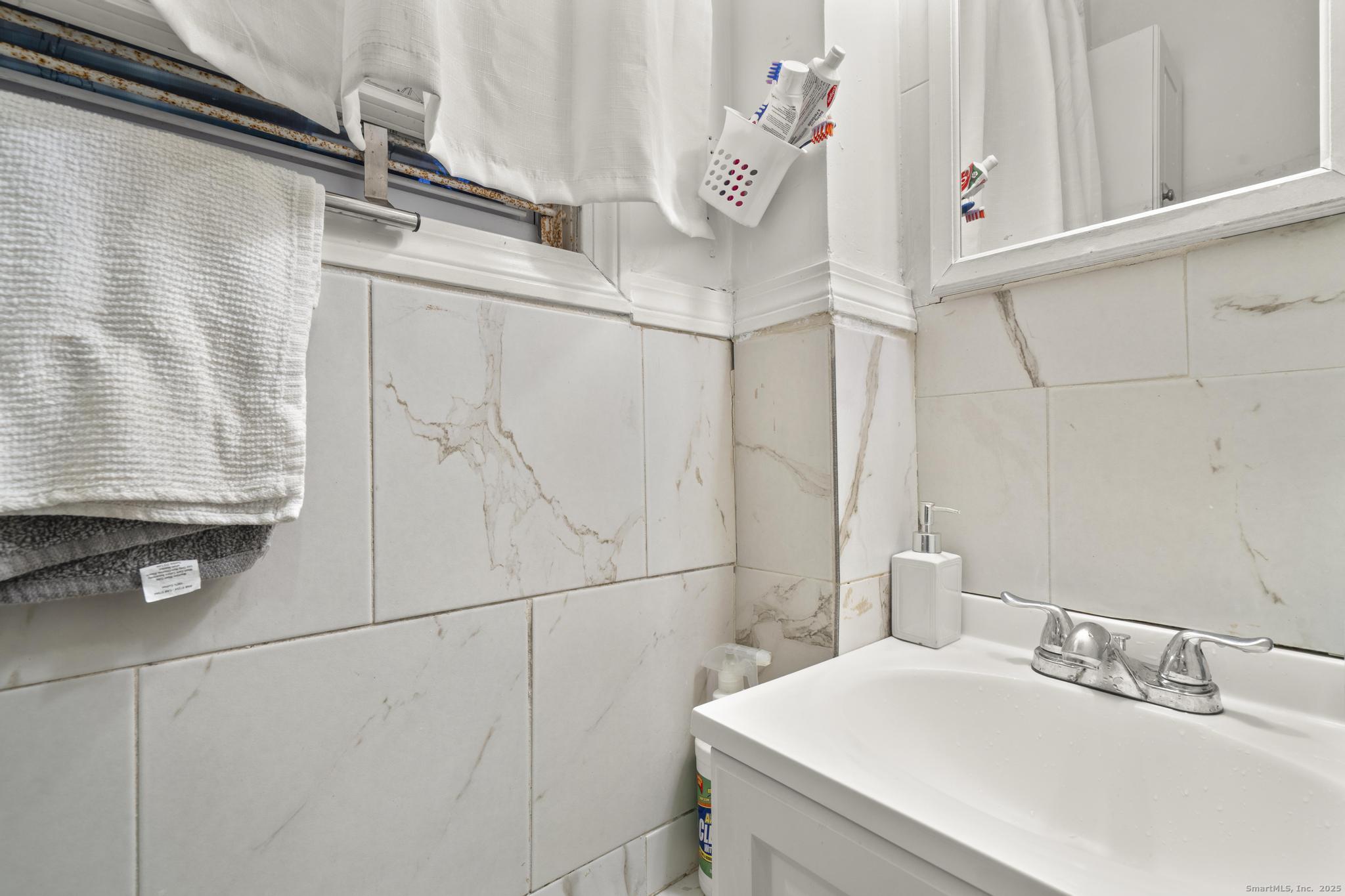 865 Iranistan Avenue Bridgeport, CT 06605 - Photo 18 of 35 a bathroom with a sink and a mirror