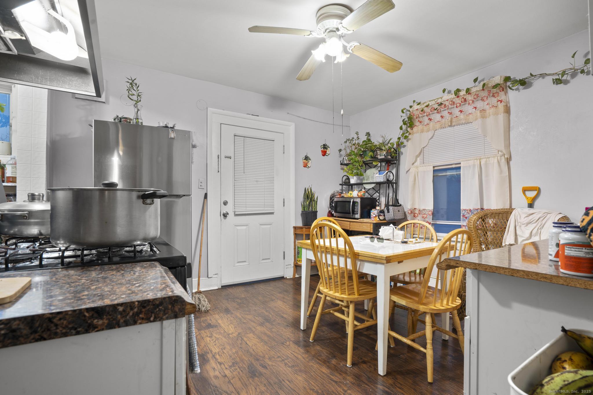 865 Iranistan Avenue Bridgeport, CT 06605 - Photo 24 of 35 a view of a dining room with furniture wooden floor and chandelier