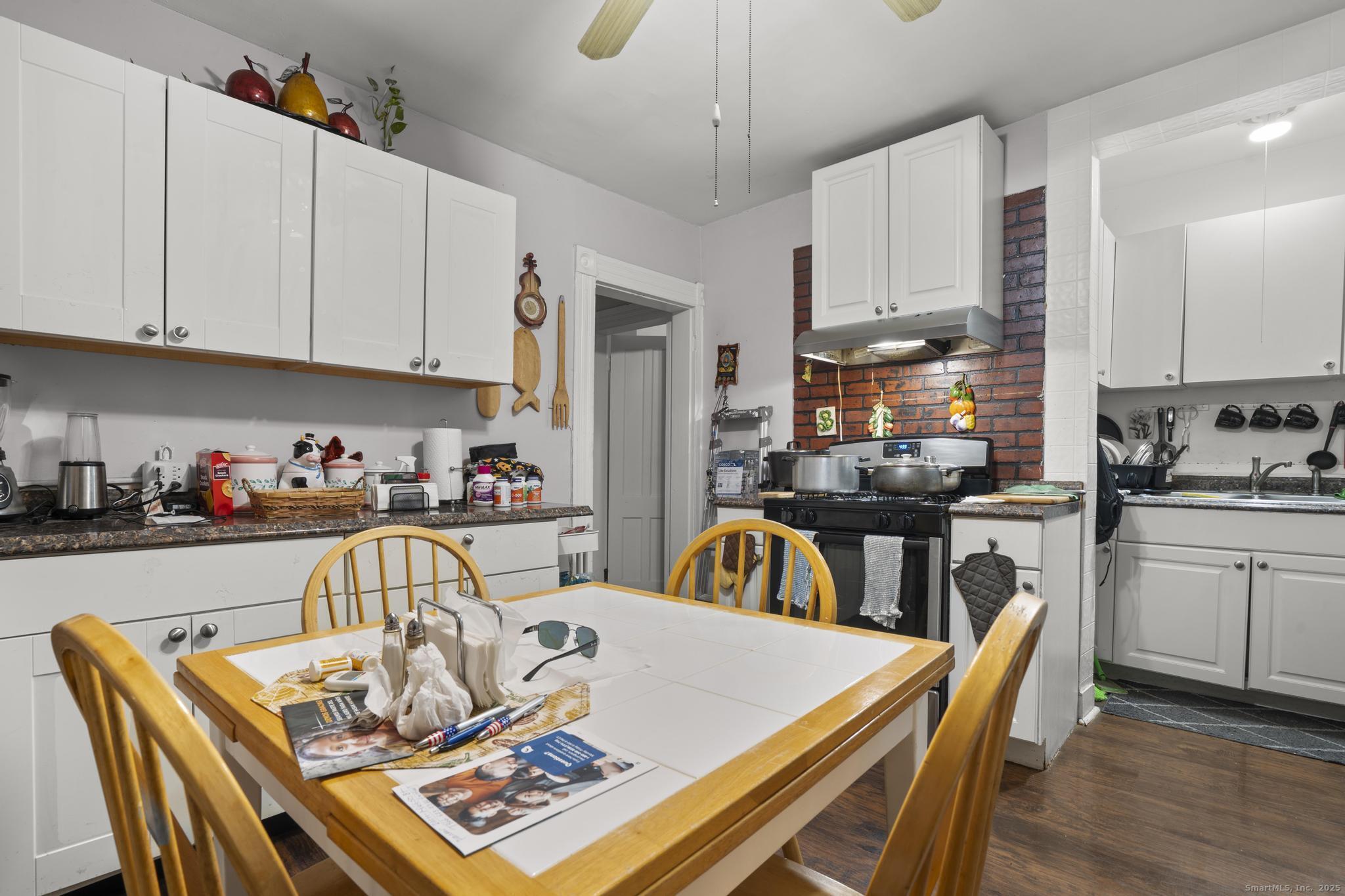 865 Iranistan Avenue Bridgeport, CT 06605 - Photo 25 of 35 a view of a dining room with furniture and wooden floor