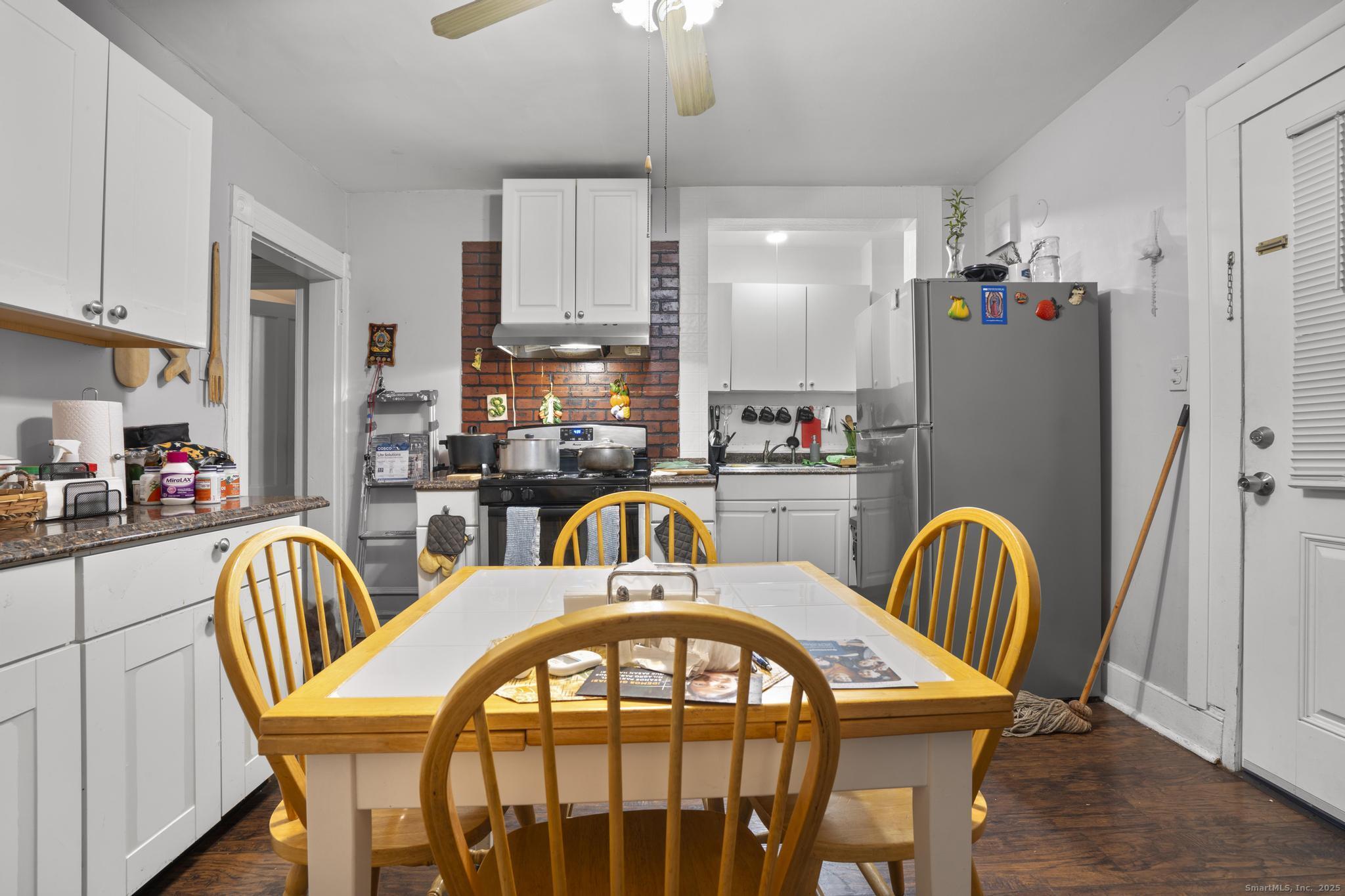 865 Iranistan Avenue Bridgeport, CT 06605 - Photo 26 of 35 a dining room with furniture and a chandelier