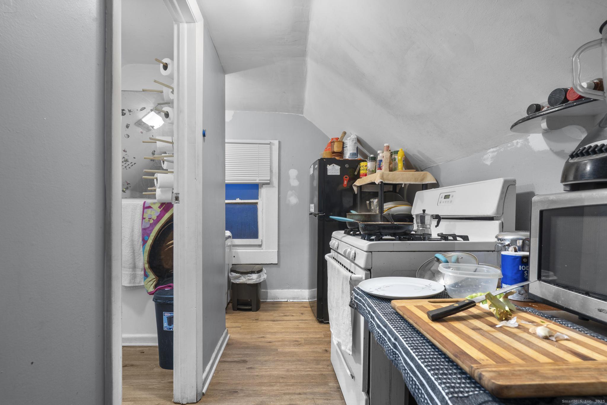 865 Iranistan Avenue Bridgeport, CT 06605 - Photo 28 of 35 a kitchen with a refrigerator and a sink