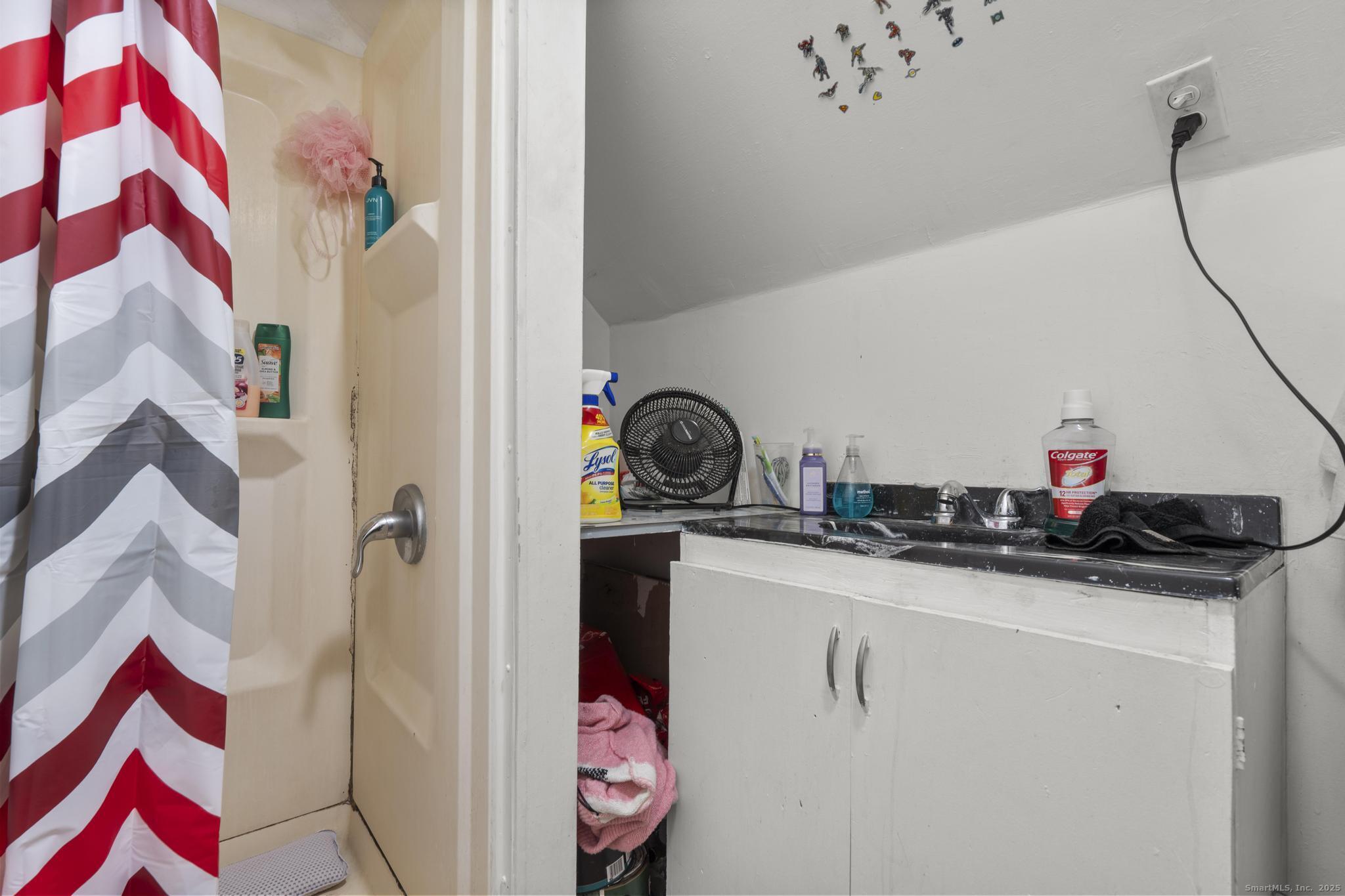 865 Iranistan Avenue Bridgeport, CT 06605 - Photo 29 of 35 a bathroom with a sink and a mirror