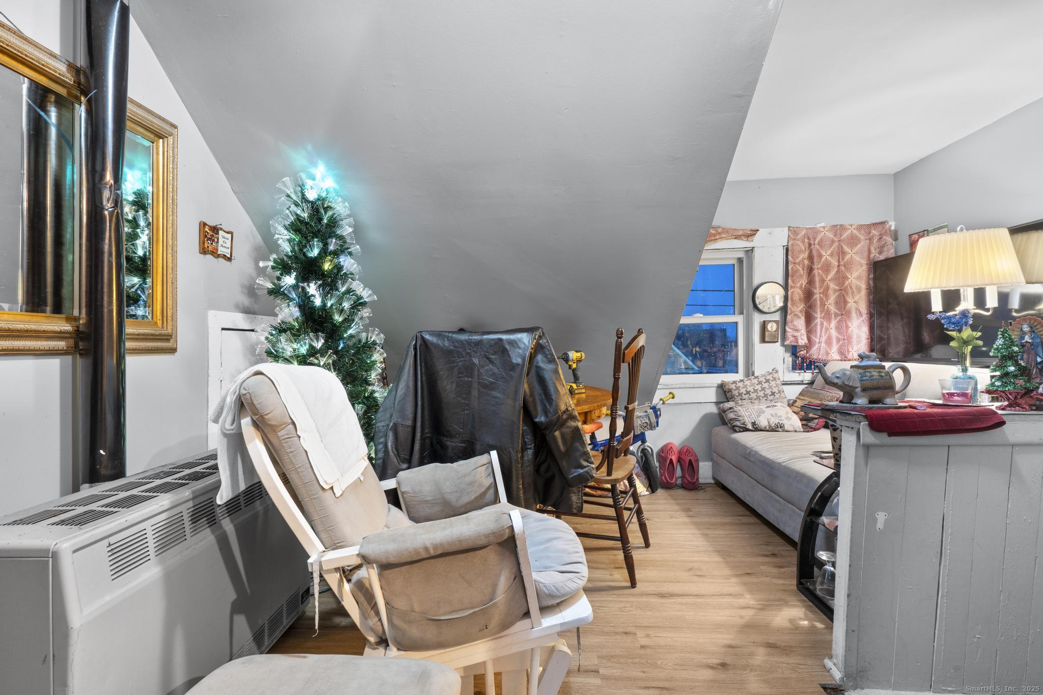 865 Iranistan Avenue Bridgeport, CT 06605 - Photo 30 of 35 a living room with furniture and a potted plant