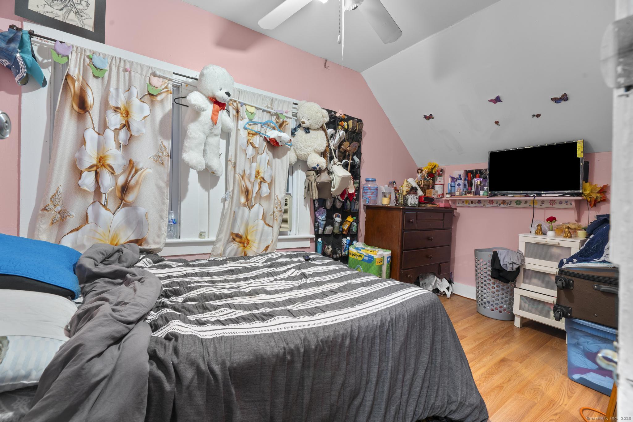 865 Iranistan Avenue Bridgeport, CT 06605 - Photo 31 of 35 a bedroom with a bed and a flat screen tv