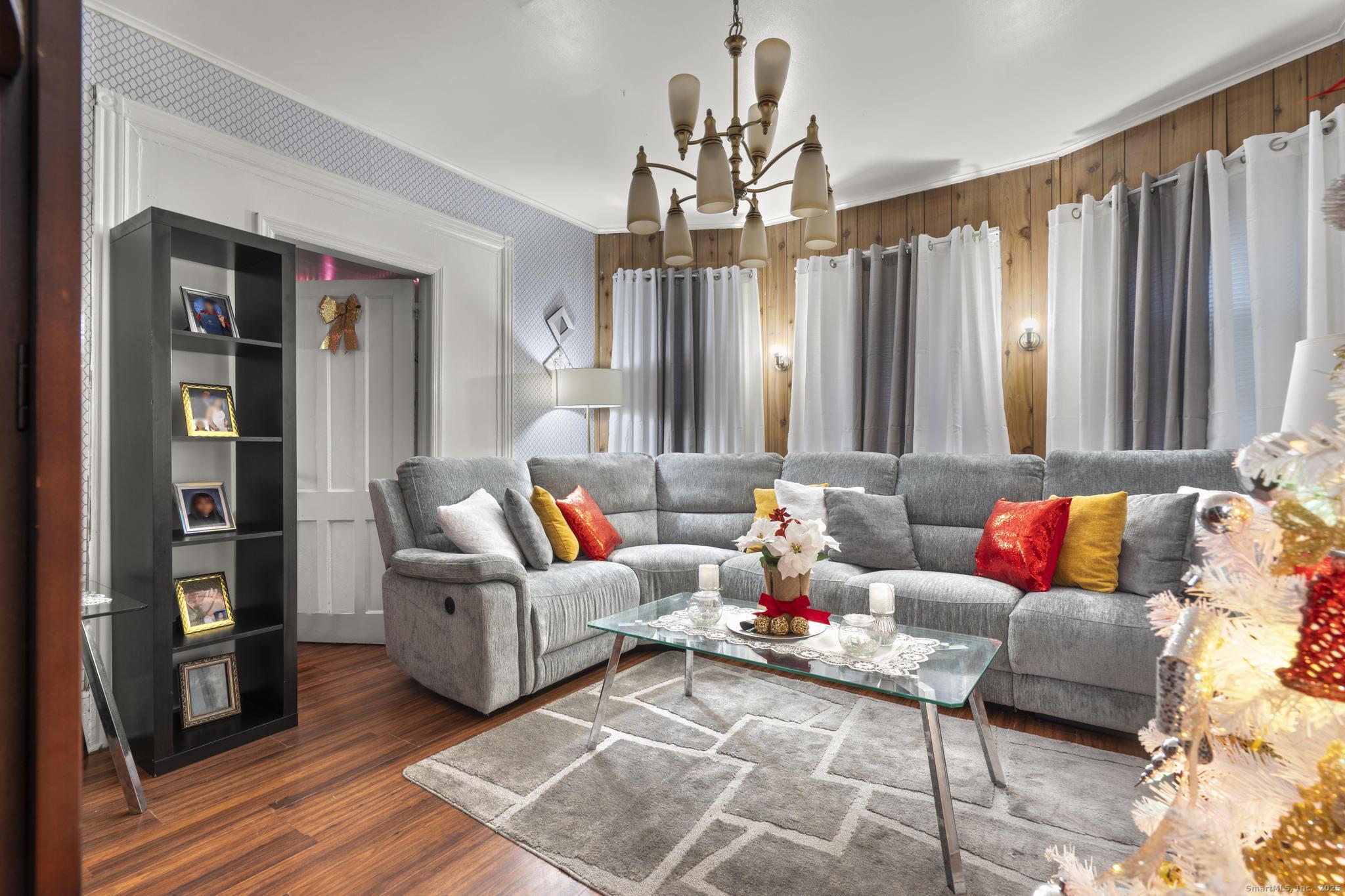 865 Iranistan Avenue Bridgeport, CT 06605 - Photo 7 of 35 a living room with furniture and a chandelier