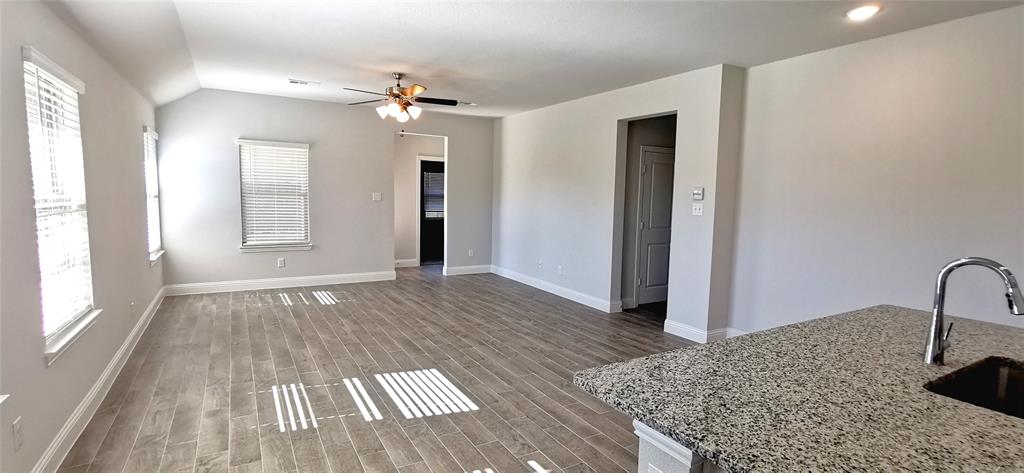 2131 Erika Lane Forney, TX 75126 - Photo 11 of 20 a view of a livingroom with wooden floor and a cabinet