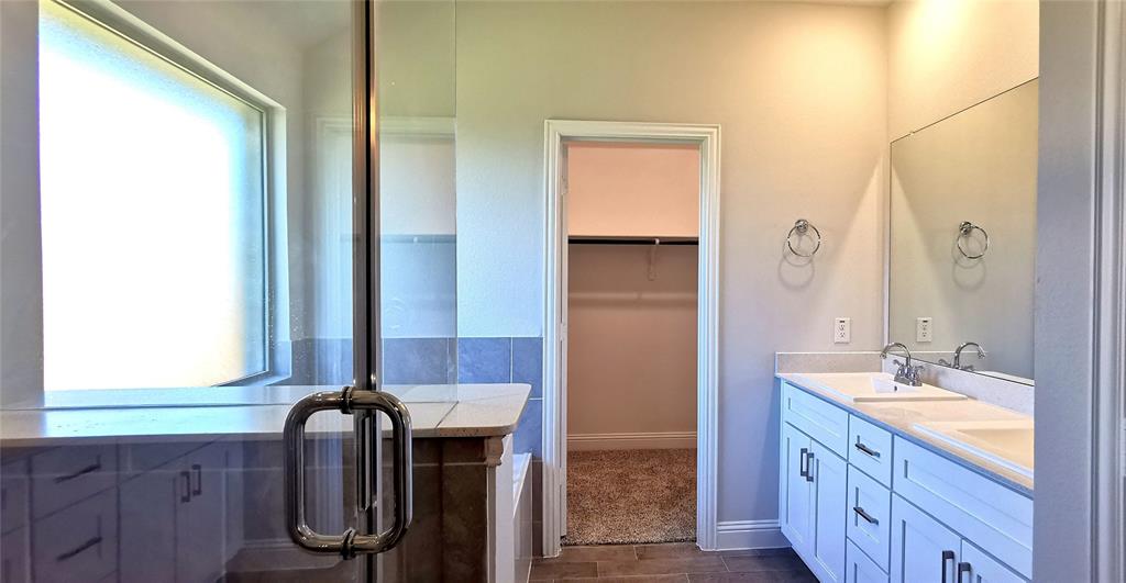 2131 Erika Lane Forney, TX 75126 - Photo 13 of 20 a bathroom with a double vanity sink and a mirror