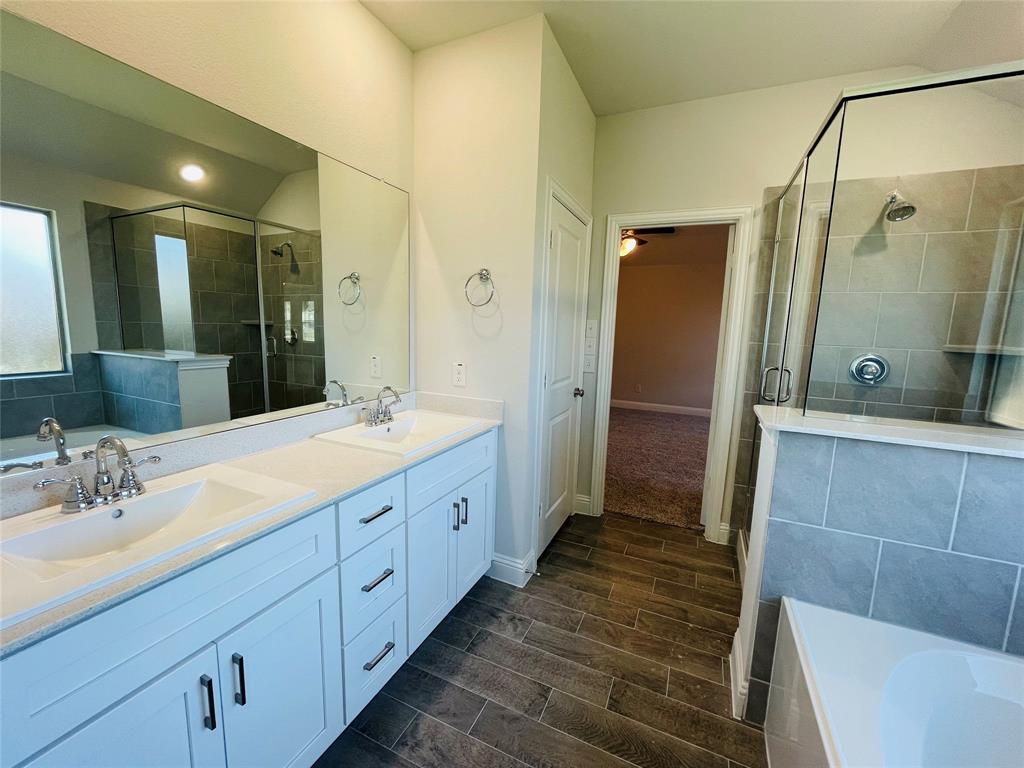 2131 Erika Lane Forney, TX 75126 - Photo 14 of 20 a bathroom with a double vanity sink a large mirror and shower
