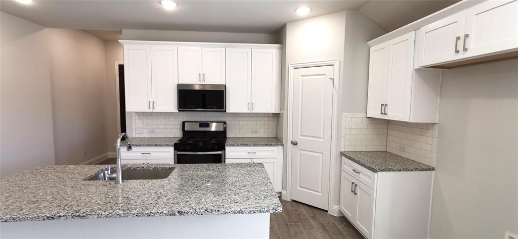 2131 Erika Lane Forney, TX 75126 - Photo 7 of 20 a kitchen with stainless steel appliances granite countertop a granite counter tops and a refrigerator