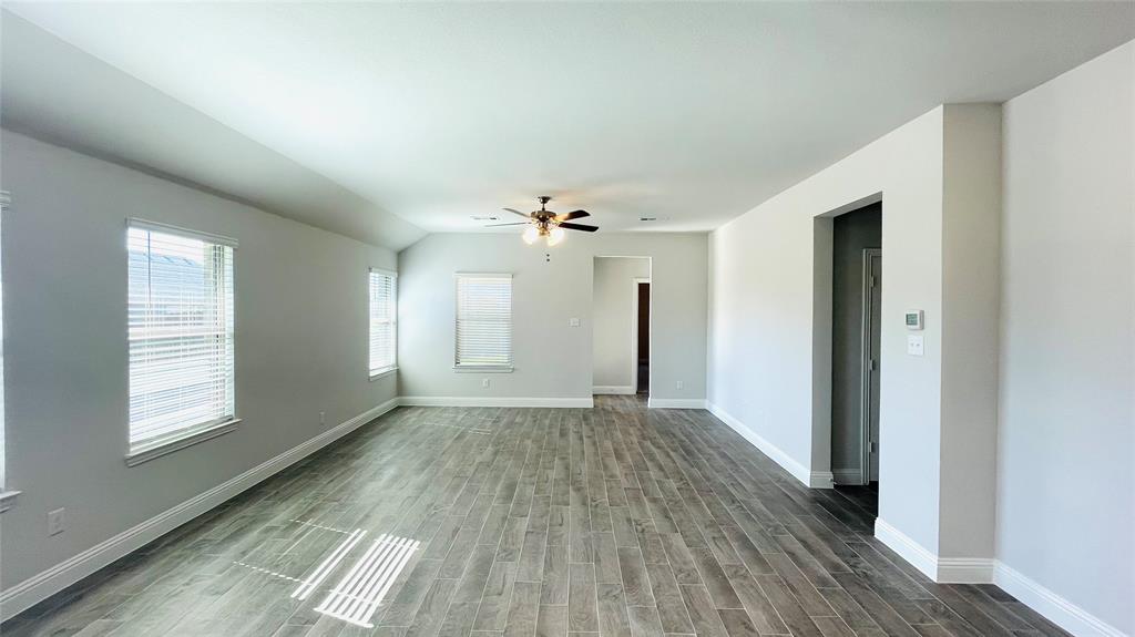 2131 Erika Lane Forney, TX 75126 - Photo 10 of 20 wooden floor in an empty room with a window