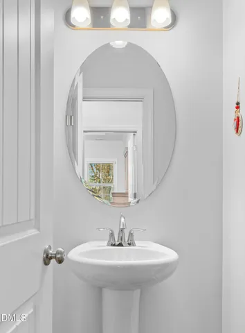 a bathroom with a sink a mirror and vanity