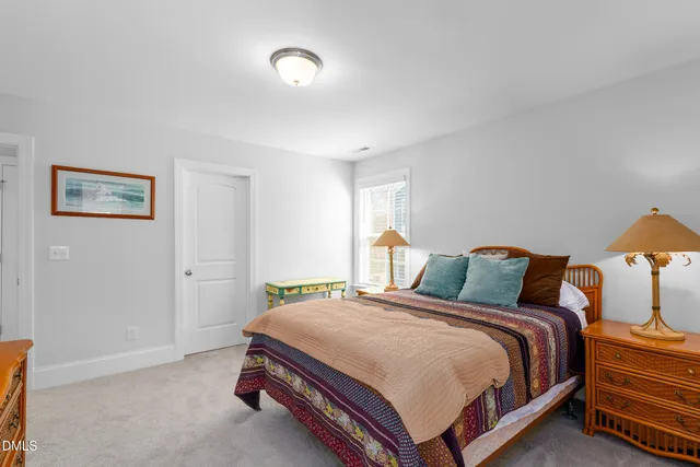 a bed room with a bed and two large window