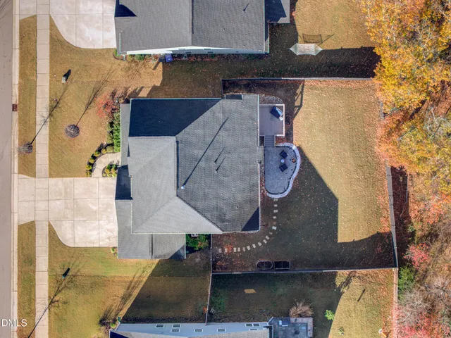 an aerial view of a house with a yard