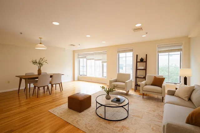 a living room with furniture and a wooden floor