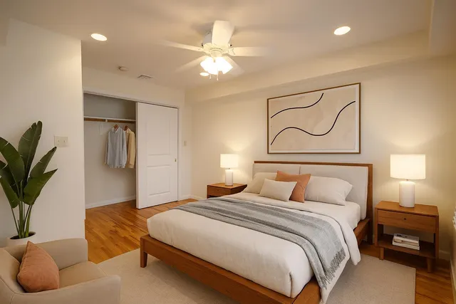 a bedroom with a large bed and chandelier