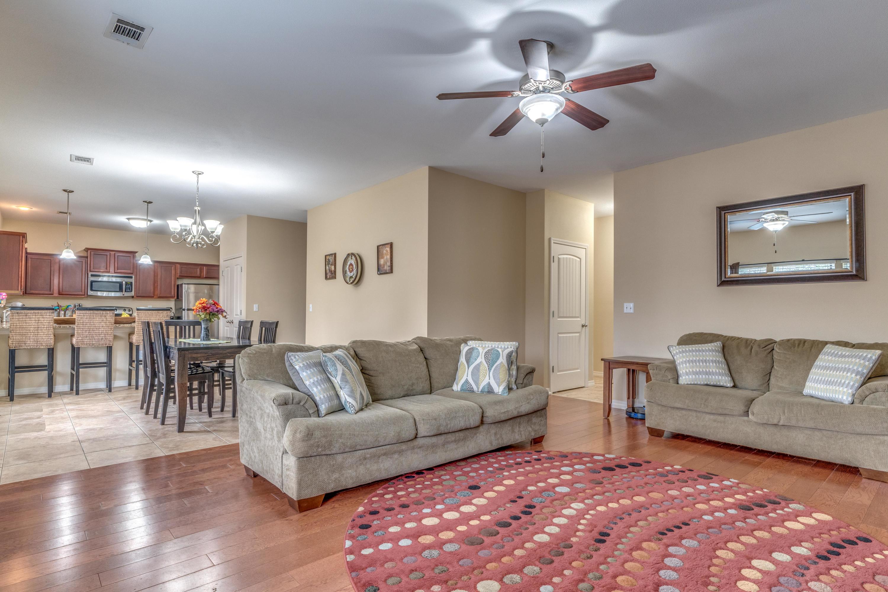180 Peoria Boulevard Crestview, FL 32536 - Photo 11 of 33 a living room with furniture and a dining table with wooden floor
