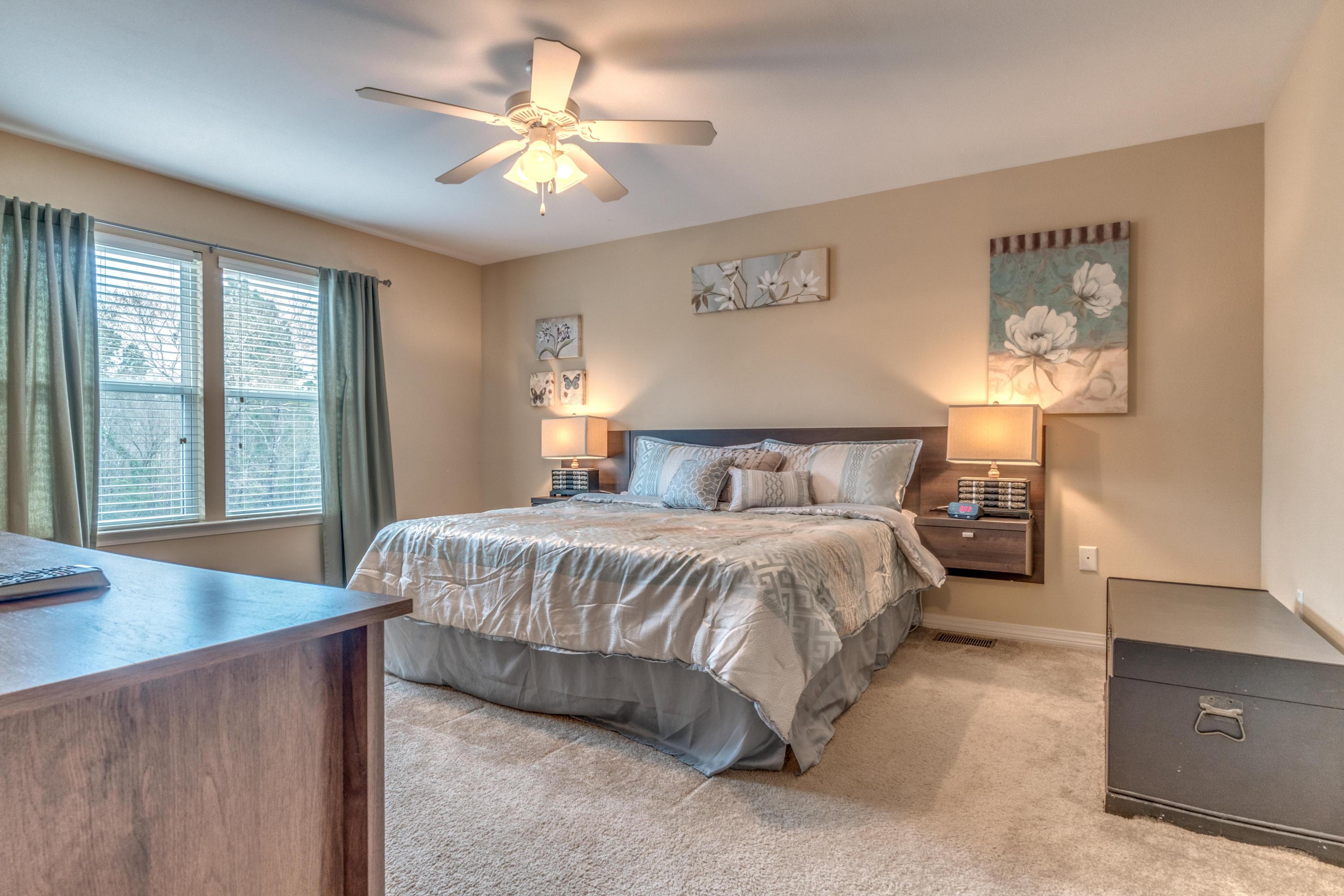 180 Peoria Boulevard Crestview, FL 32536 - Photo 16 of 33 a spacious bedroom with a bed and a chandelier
