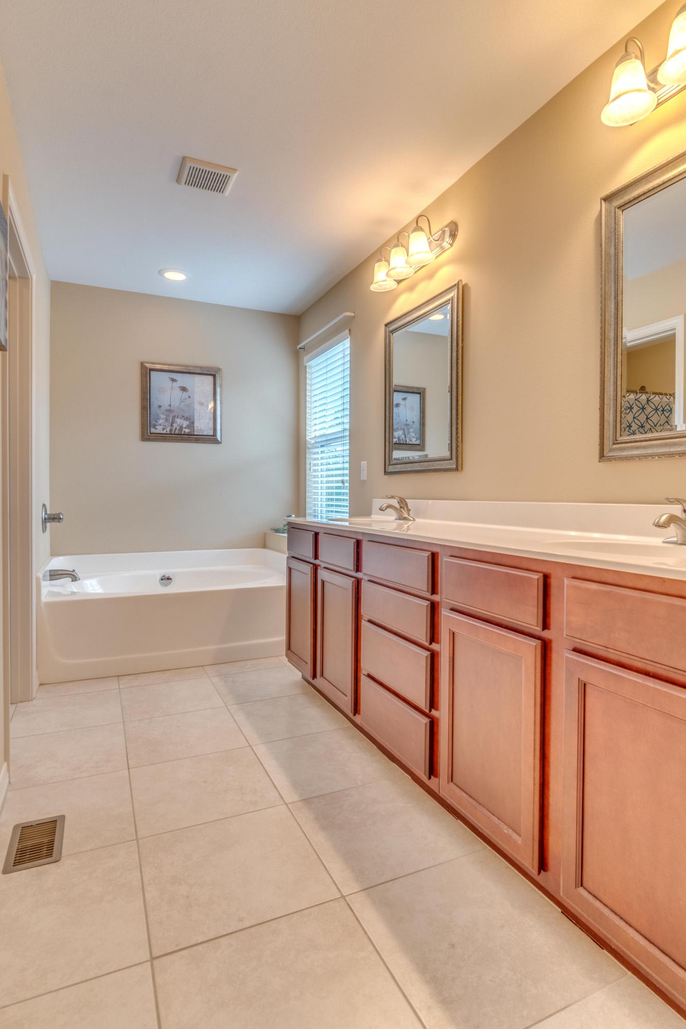 180 Peoria Boulevard Crestview, FL 32536 - Photo 17 of 33 a spacious bathroom with a tub sink and mirror