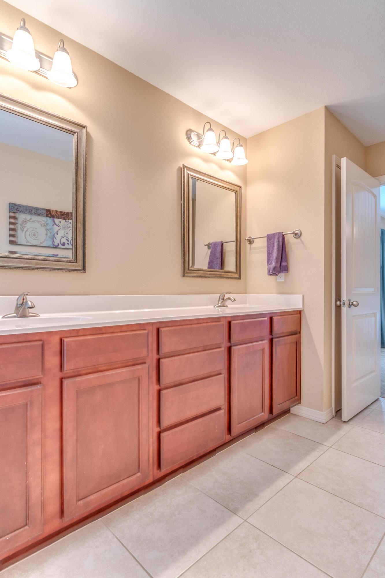 180 Peoria Boulevard Crestview, FL 32536 - Photo 18 of 33 a spacious bathroom with a granite countertop sink and a mirror