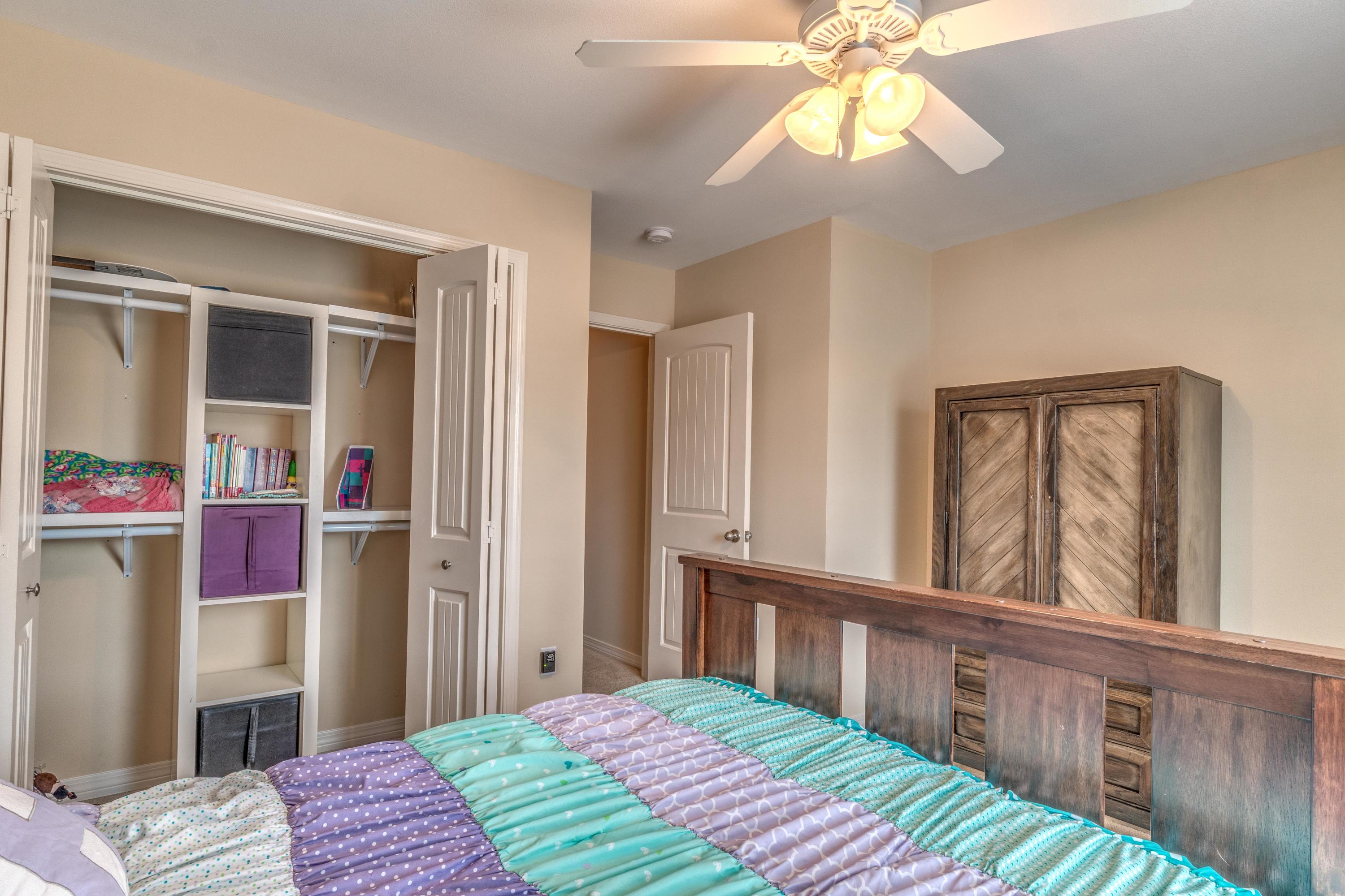 180 Peoria Boulevard Crestview, FL 32536 - Photo 26 of 33 a bedroom with a bed and a chandelier