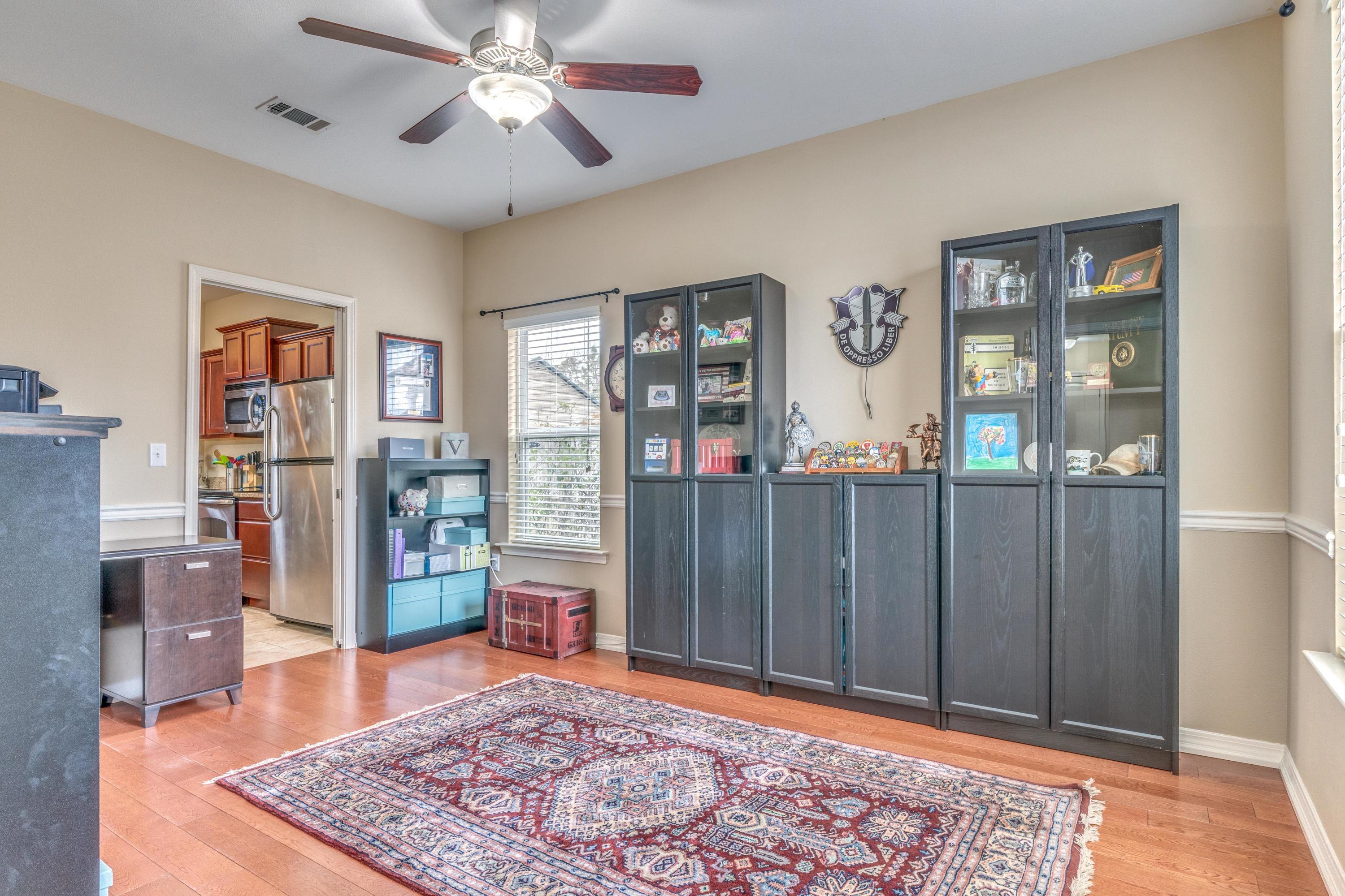 180 Peoria Boulevard Crestview, FL 32536 - Photo 5 of 33 a living room with stainless steel appliances lots of furniture and wooden floor