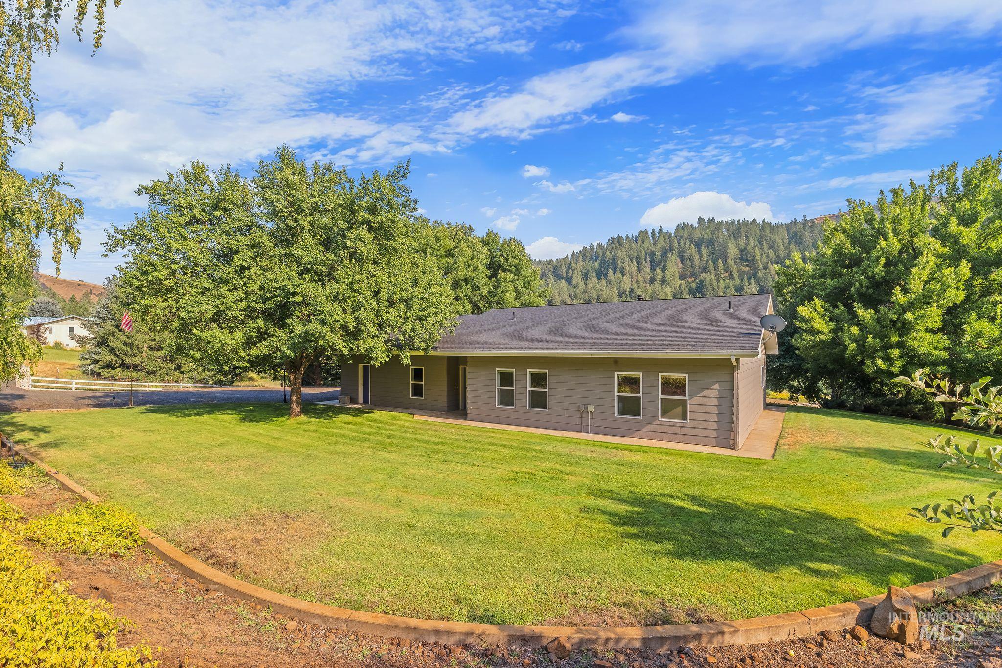 1091 Cedar Ridge Road Kendrick, ID 83537 - Photo 7 of 48 Single-story home featuring gray horizontal siding and white-framed windows