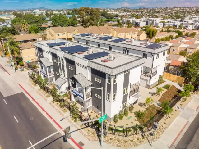 an aerial view of a residential apartment building with a yard