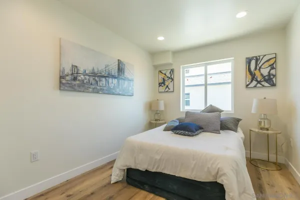 a bedroom with a bed and a window