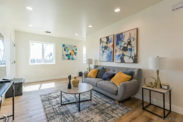a living room with furniture a rug and a window