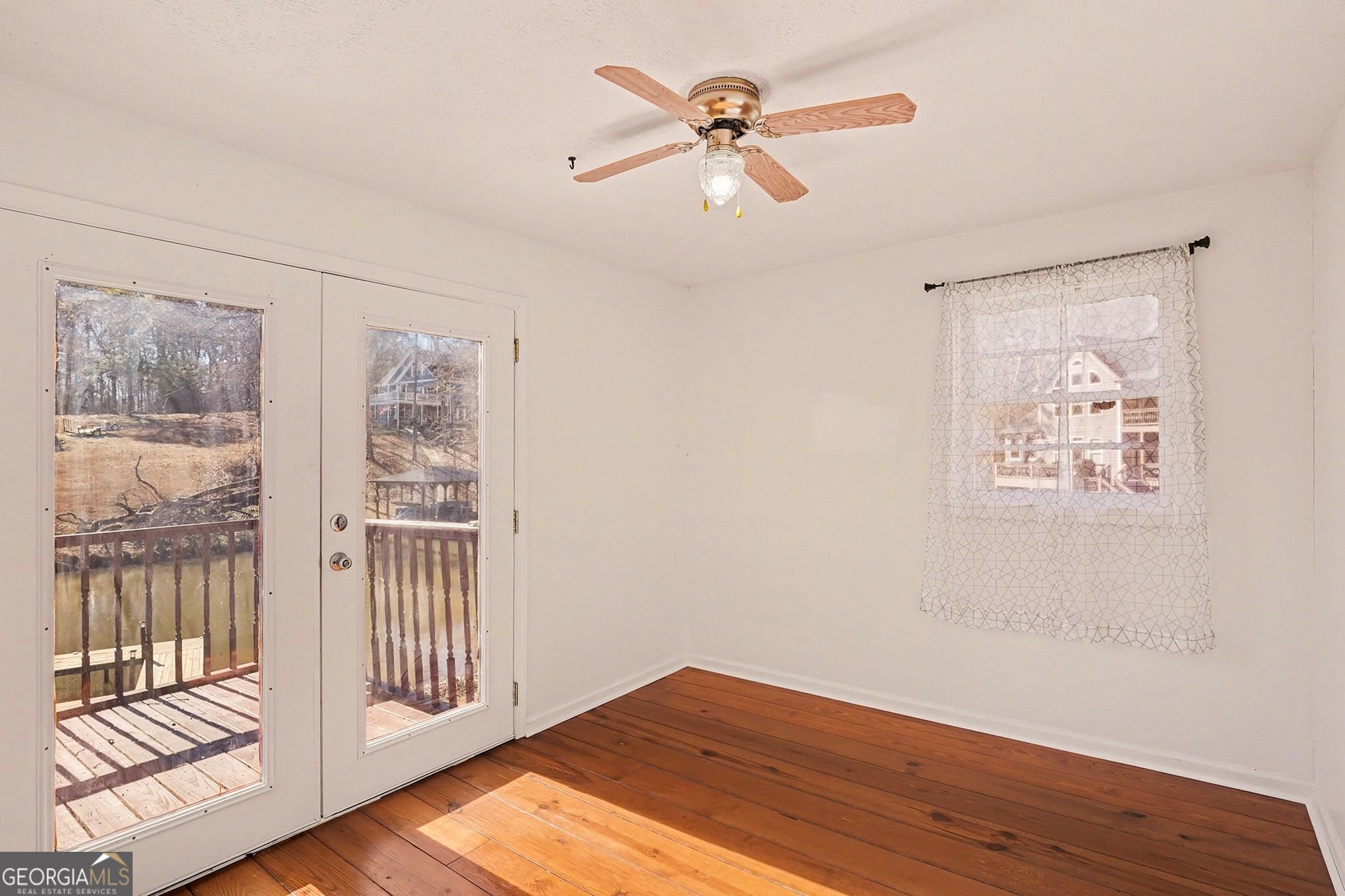 70 Birch Road Covington, GA 30014 - Photo 15 of 23 wooden floor in an empty room with a window