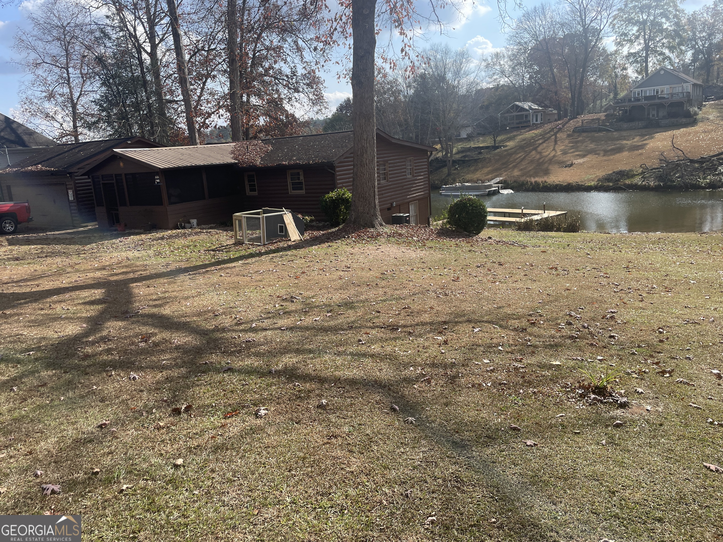 70 Birch Road Covington, GA 30014 - Photo 3 of 23 a backyard of a house with table and chairs under an umbrella