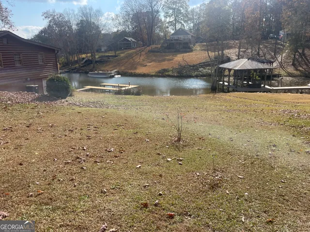 a view of swimming pool with outdoor seating and plants