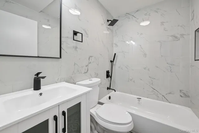 a bathroom with a bathtub and a sink