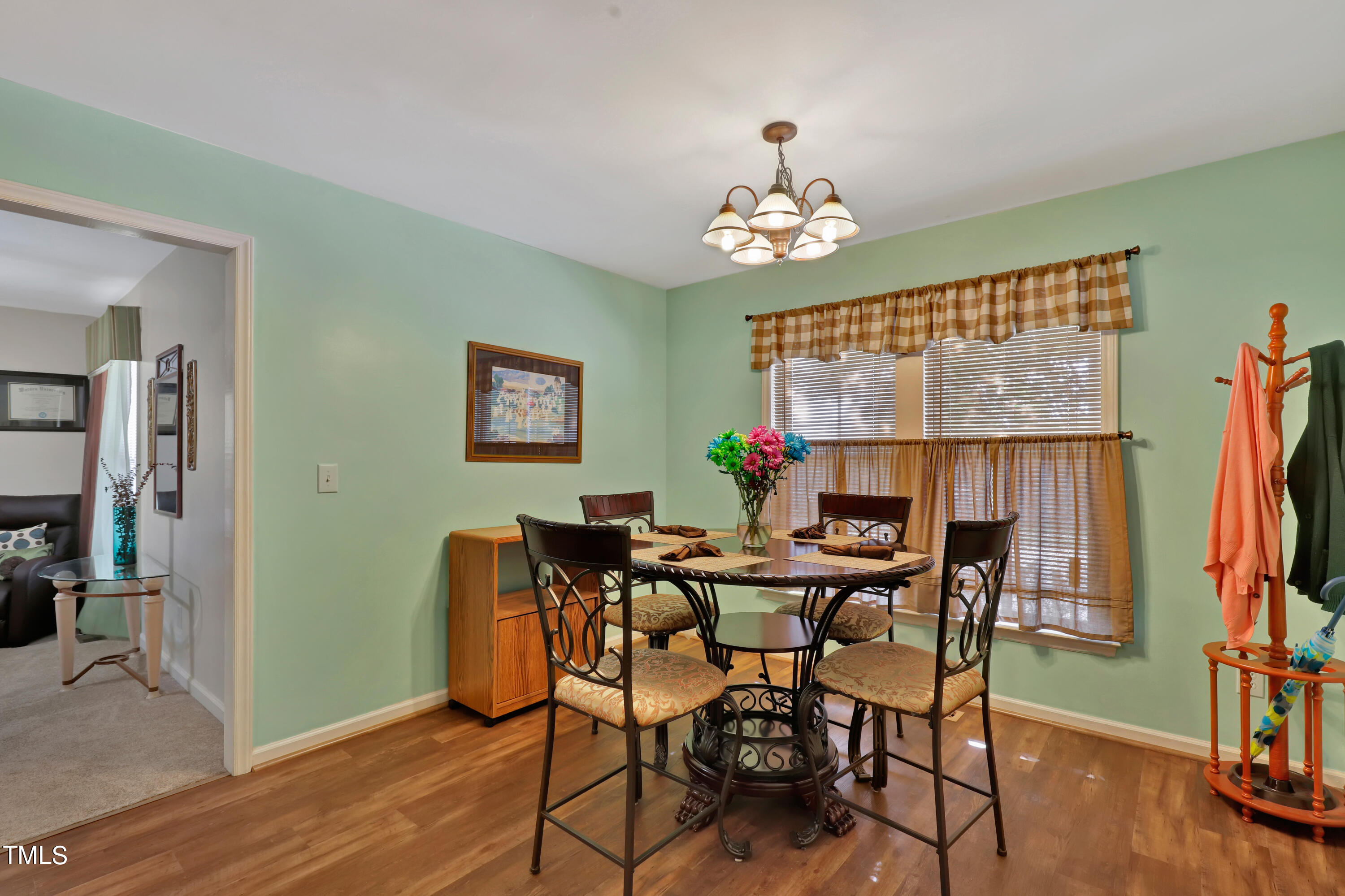 603 East Martin Street Raleigh, NC 27601 - Photo 11 of 25 a view of a dining room with furniture wooden floor and a chandelier
