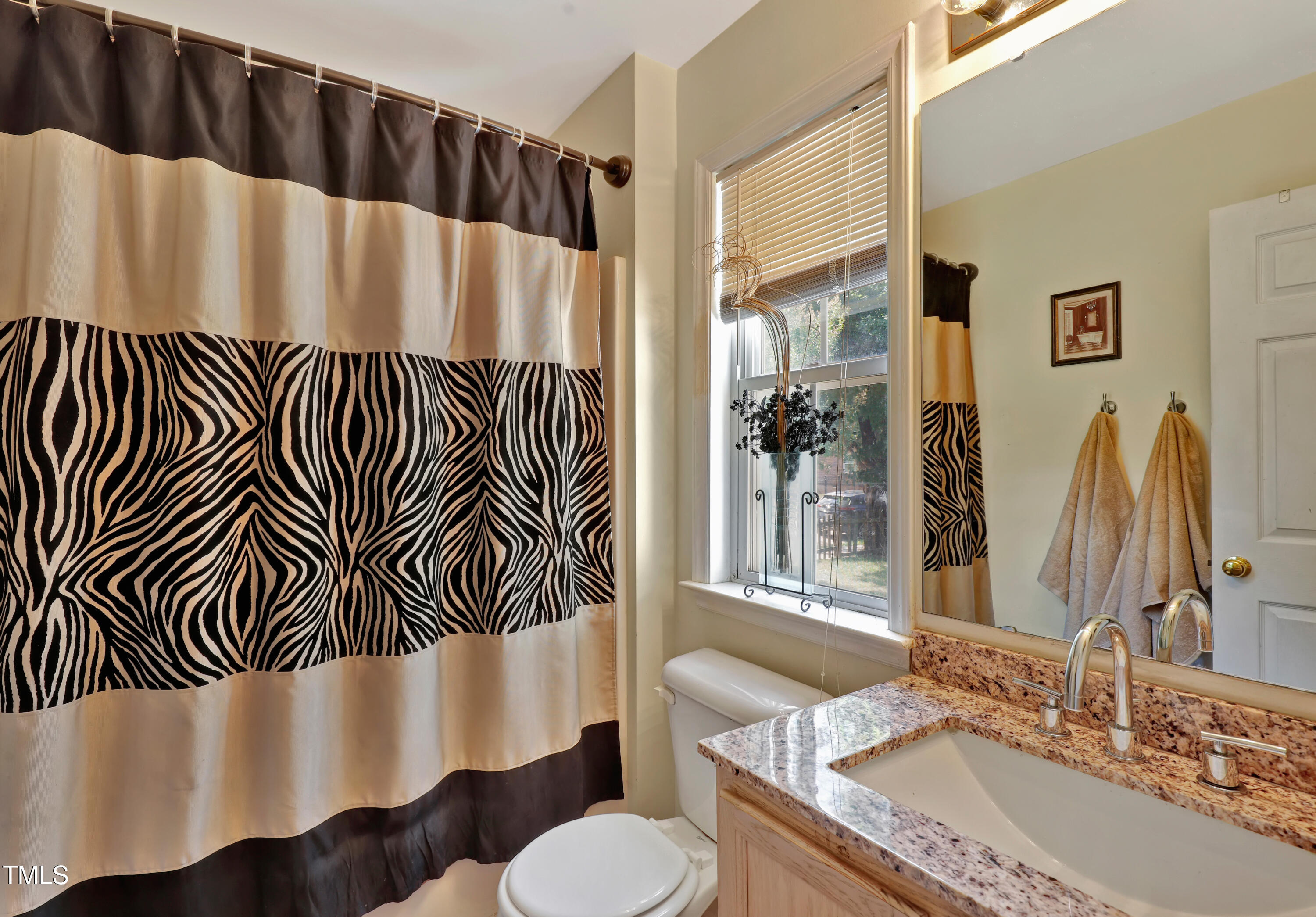 603 East Martin Street Raleigh, NC 27601 - Photo 15 of 25 a bathroom with a granite countertop sink and a mirror