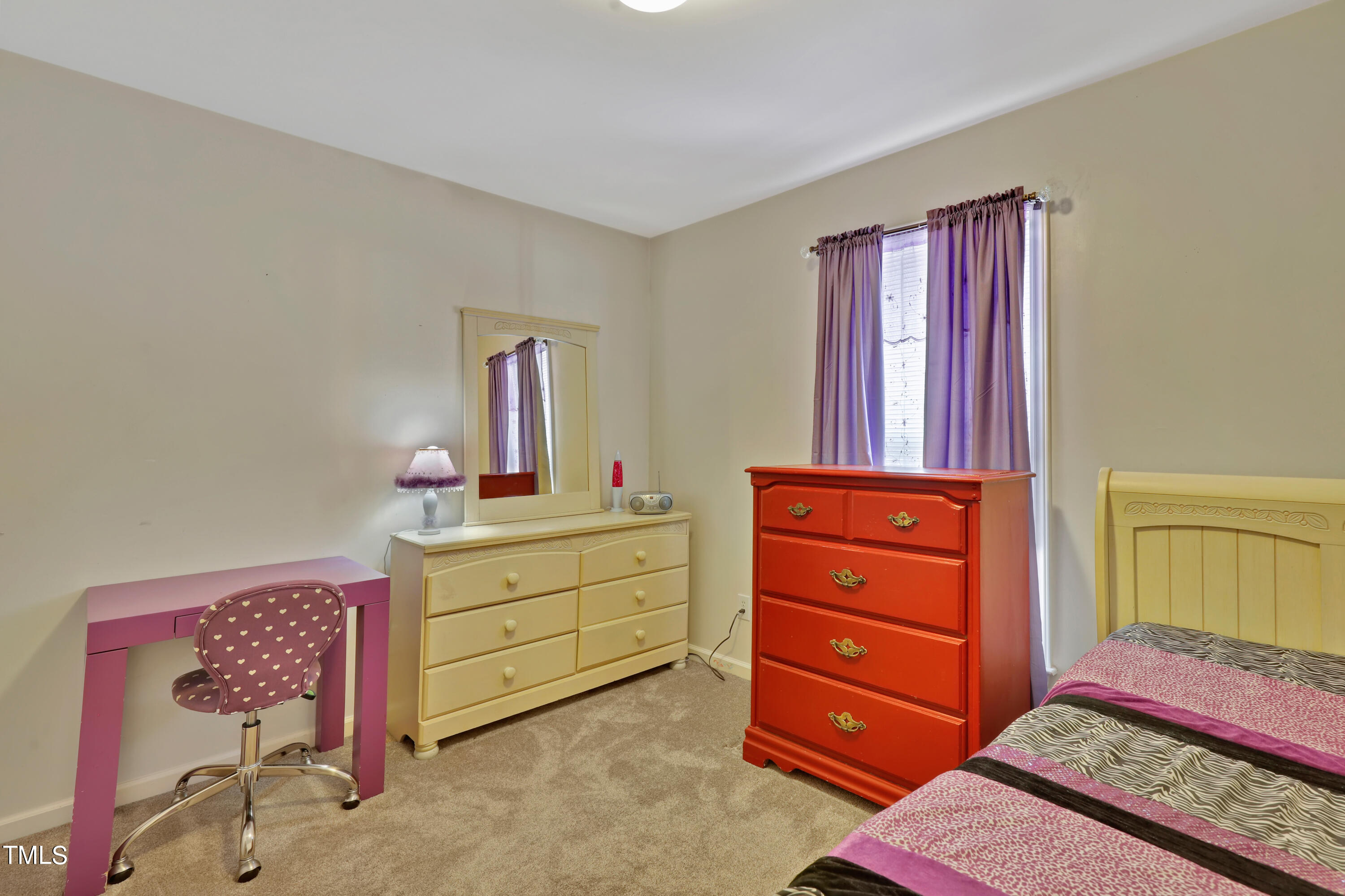 603 East Martin Street Raleigh, NC 27601 - Photo 16 of 25 a bedroom with a bed and a dresser in it