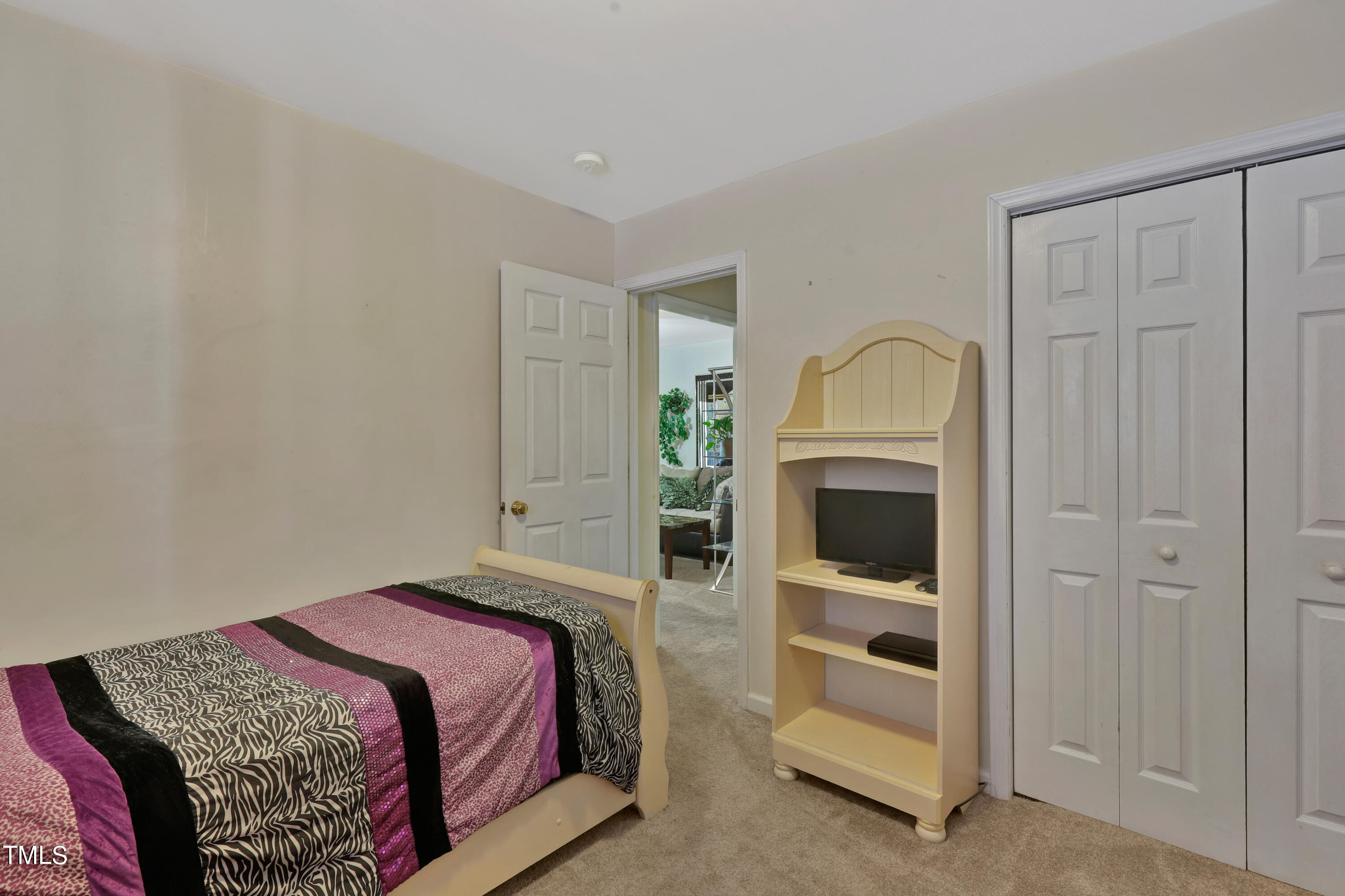 603 East Martin Street Raleigh, NC 27601 - Photo 17 of 25 a bedroom with a bed and a fireplace