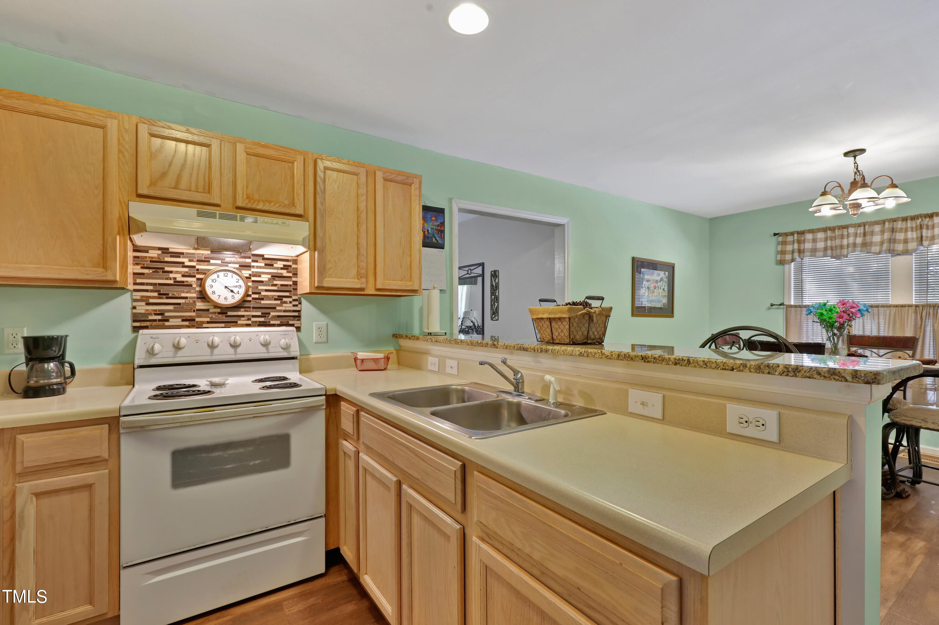 603 East Martin Street Raleigh, NC 27601 - Photo 8 of 25 a kitchen with a stove sink and cabinets
